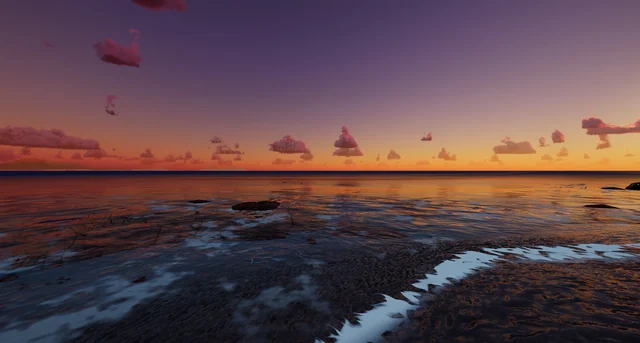 The shore at sunset, with an orange and violet sky